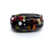 Load image into Gallery viewer, Single lampwork glass bead in black with green and colourful design