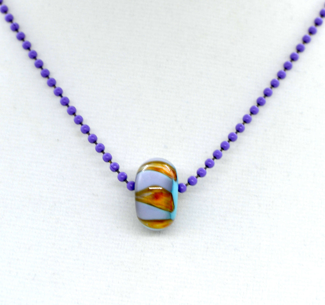 Blue core with orange and purple encased in clear glass bead on ball chain