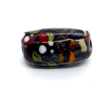 Load image into Gallery viewer, Single lampwork glass bead in black with green and colourful design
