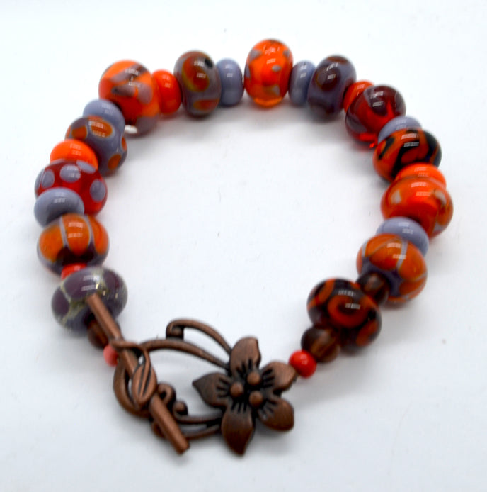 Vibrancy in orange and purple -Lampwork Glass Bead Bracelet